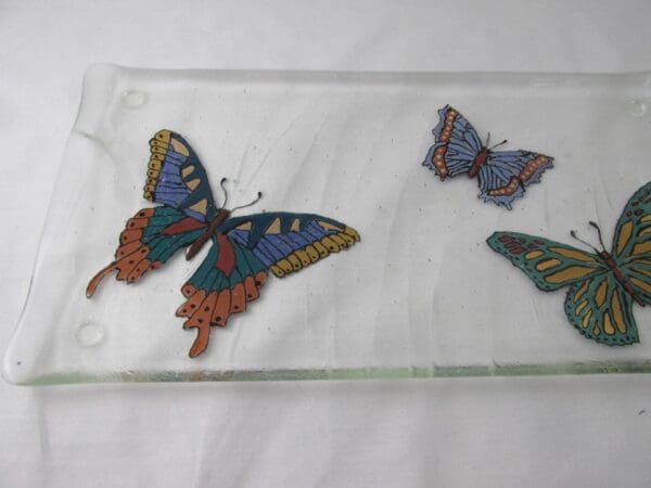 TR17005 - Hand painted Butterfly Textured Tray, adorned with vibrant blue, orange, green, and yellow butterfly patterns on a white background.