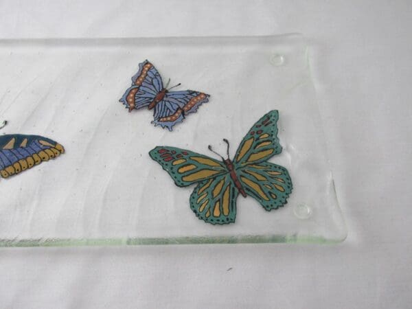 Hand painted Butterfly Textured Tray featuring three butterflies in shades of blue and green on a white surface.