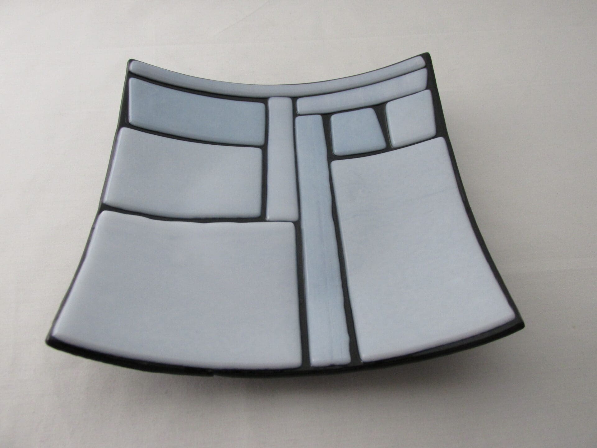 A square plate with black and white design on it.