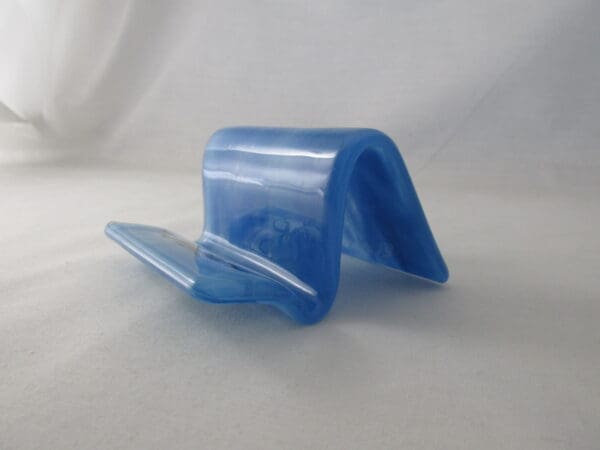 A blue plastic object sitting on top of a table.