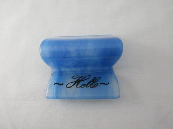 A blue plastic container with the word hello written on it.