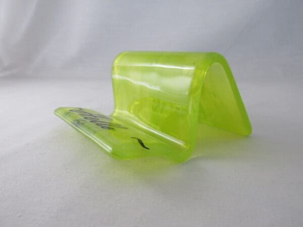 A green plastic container sitting on top of a table.