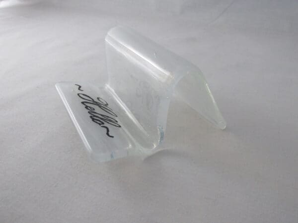 A clear plastic stand with a black and white design.