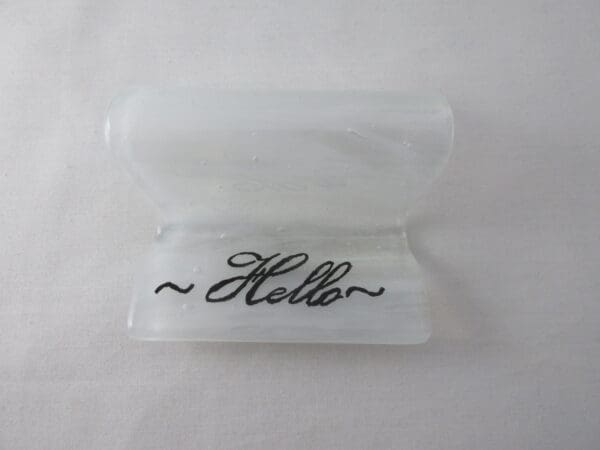 A plastic container with the word hello written on it.