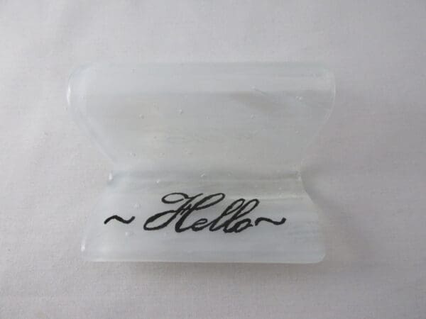 A white plastic container with the word hello written on it.