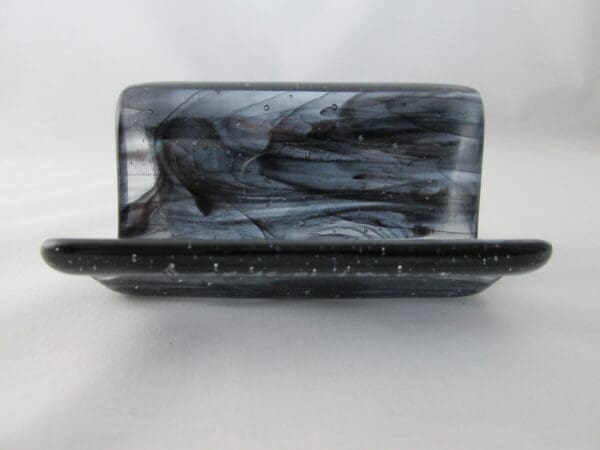 A black and white soap bar sitting on top of a counter.