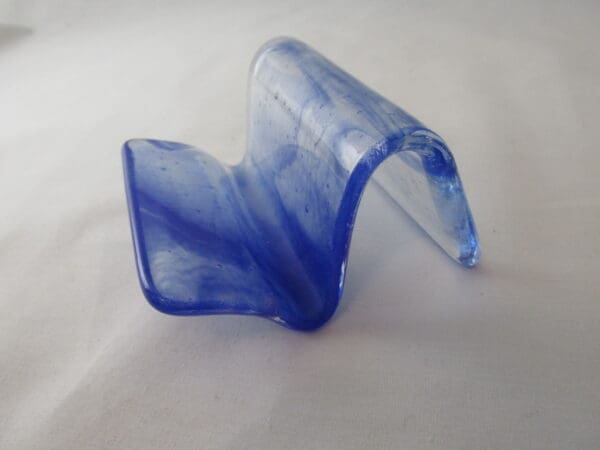 A blue plastic object sitting on top of a table.