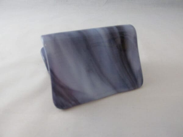 A black and white marble pattern wallet sitting on top of a table.