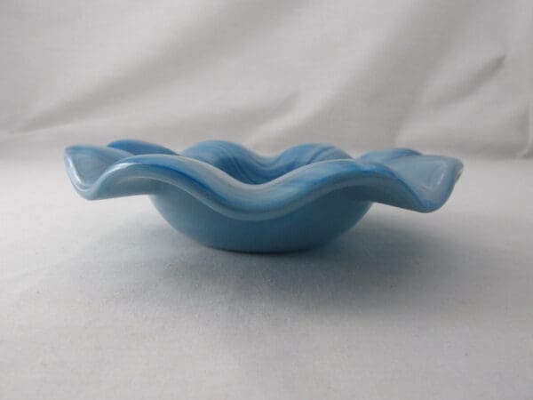 A blue bowl sitting on top of a table.