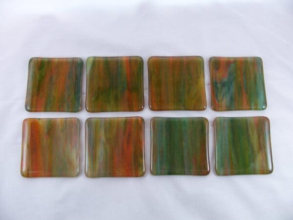 A set of eight coasters in green and orange.