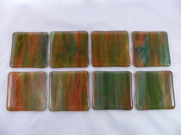 A set of eight green and orange coasters.