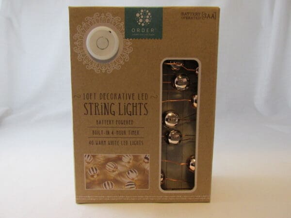 A box of string lights with a package inside