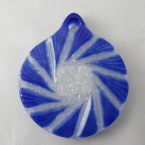 A blue and white swirl pendant on a white surface.