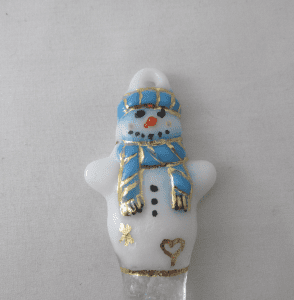 A white and blue snowman with gold trim.