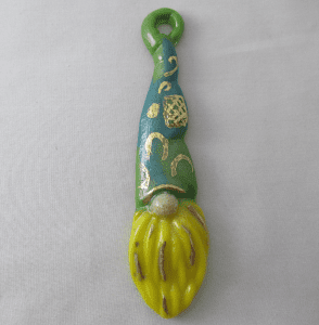 A green and yellow brush with a face on it.