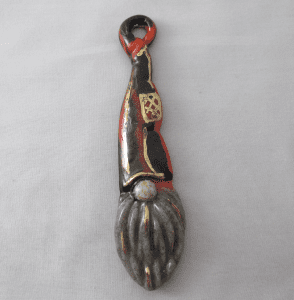 A spoon with a gnome design on it.