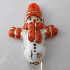 A white snowman with orange trim and gold accents.