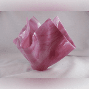 A pink bag sitting on top of a white table.