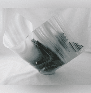 A black and white photo of a glass bowl