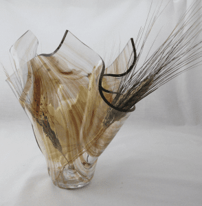 A glass vase with some feathers in it