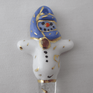 A white and blue snowman ornament with gold trim.