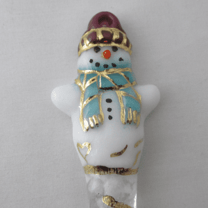 A white snowman with gold trim and blue scarf.