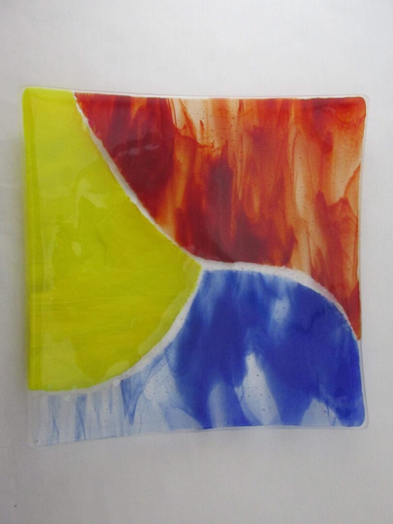 A painting of a yellow, red and blue abstract design.