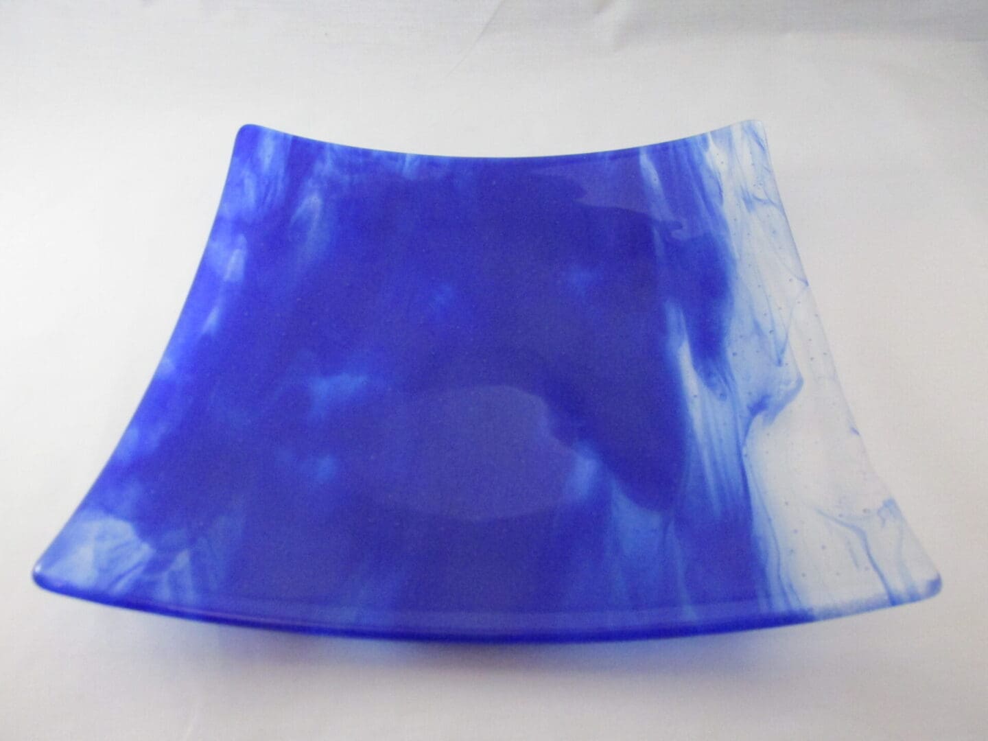 A blue and white square plate sitting on top of a table.