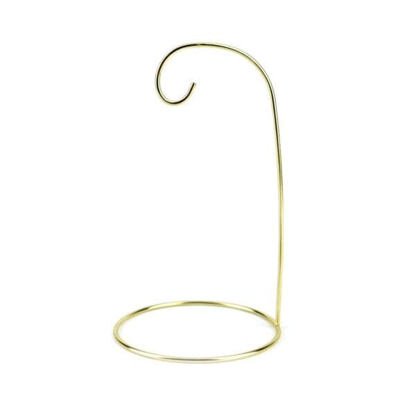 A gold ornament stand with a single loop hanging from it.