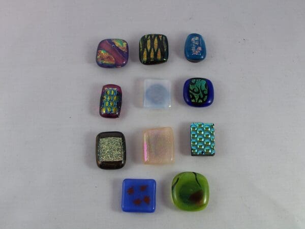 A group of different colored glass stones on top of a table.