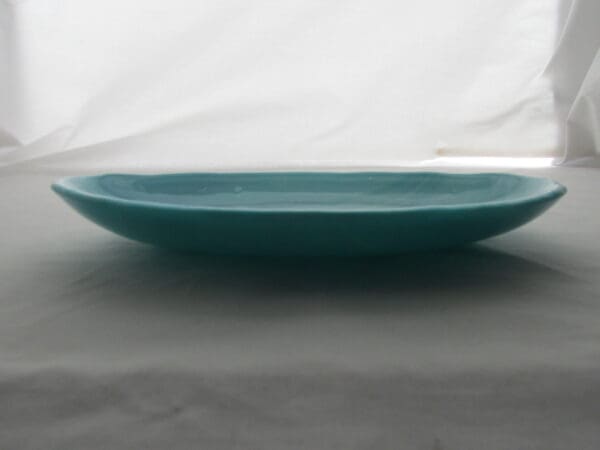 A green plate sitting on top of a table.