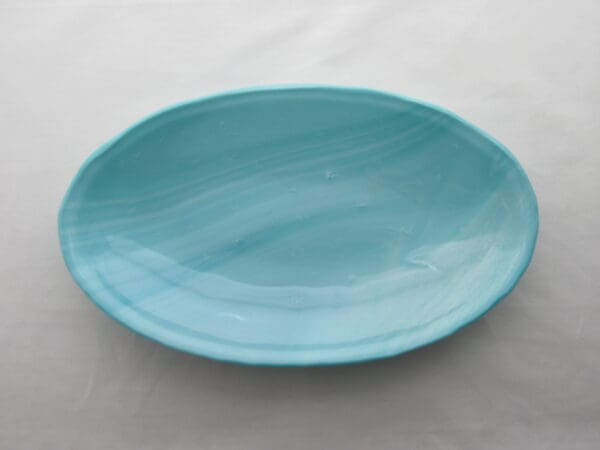 A blue plate sitting on top of a table.