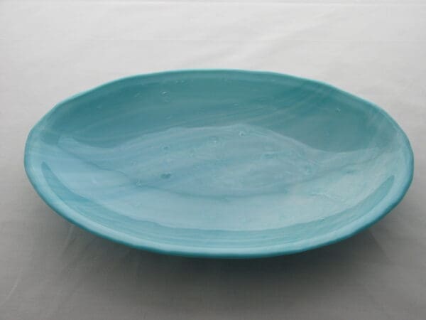 A blue plate sitting on top of a table.