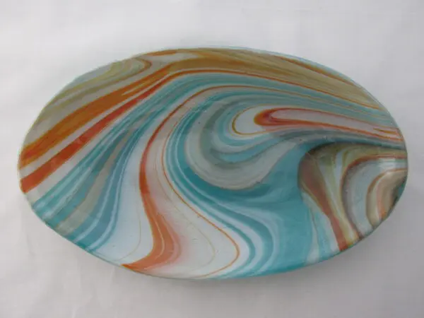 A glass plate with swirling colors on it.