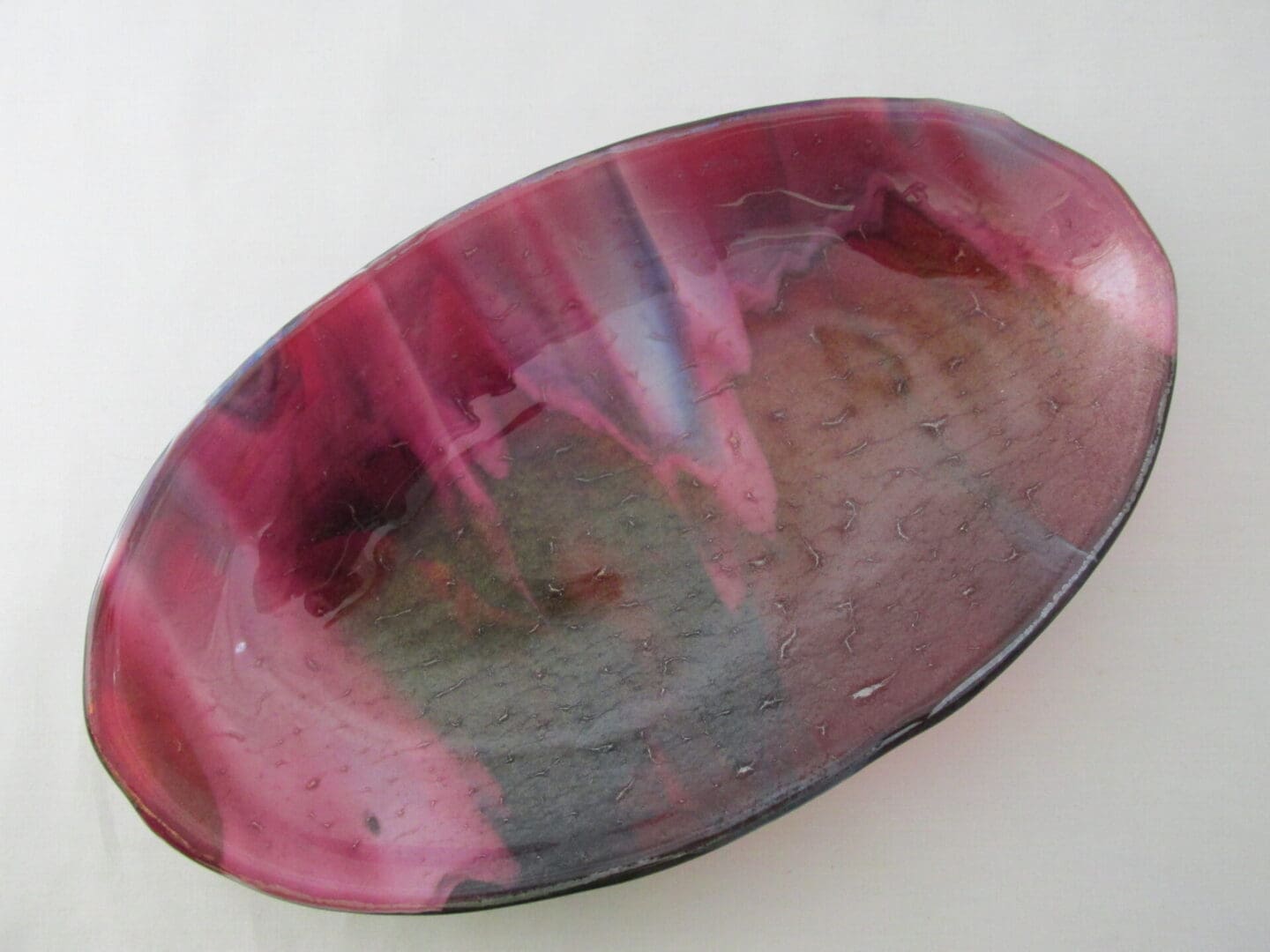 A pink and brown bowl sitting on top of a table.