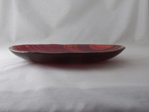 A wooden bowl sitting on top of a table.