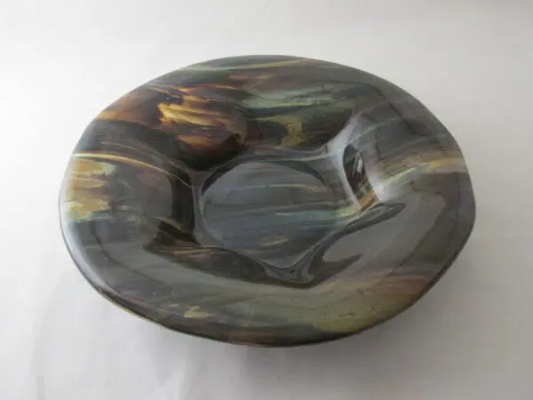 A bowl with a black and brown design on it.