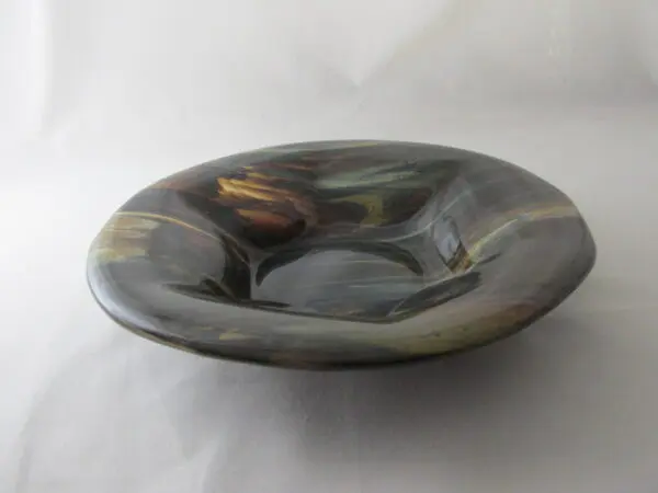 A bowl with a black and brown design on it.