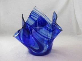 A blue glass vase with some wavy lines on it