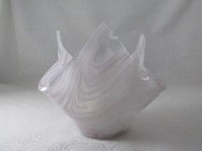 A white vase with some sort of swirling pattern.