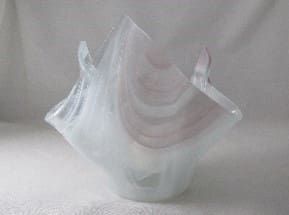 A glass sculpture of a white and pink object.