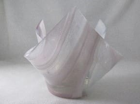 A white vase with some kind of paper