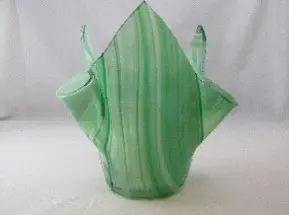 A green vase with a handle on top of it.