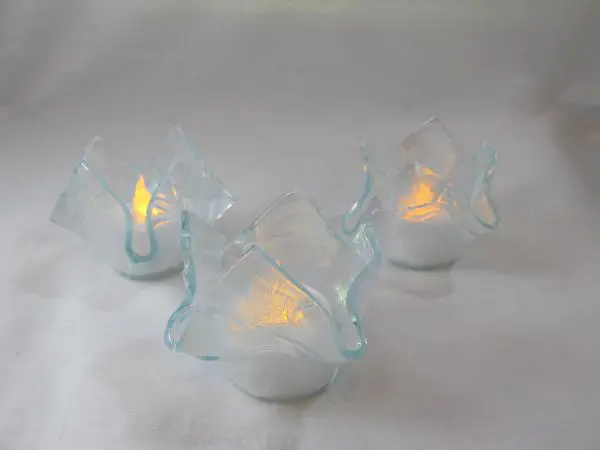 A group of three candles that are sitting on the table.