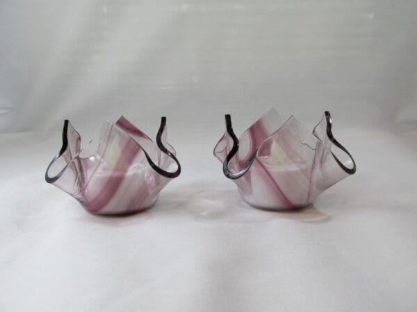 Two glass vases with a pink and white design.