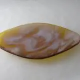 A piece of brown and white agate on top of a table.