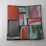 A square glass plate with some colorful squares on it