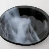 A black bowl with smoke coming out of it.