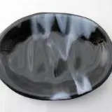 A black plate with white swirls on it