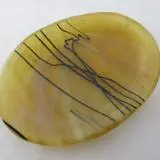 A yellow oval shaped dish with black lines on it.